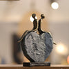 Elegant Couple on Stone Heart Sculpture