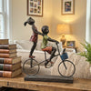 Children Riding a Bicycle Sculpture